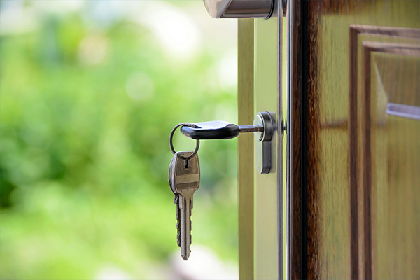 A set of keys hang from a lock on a door